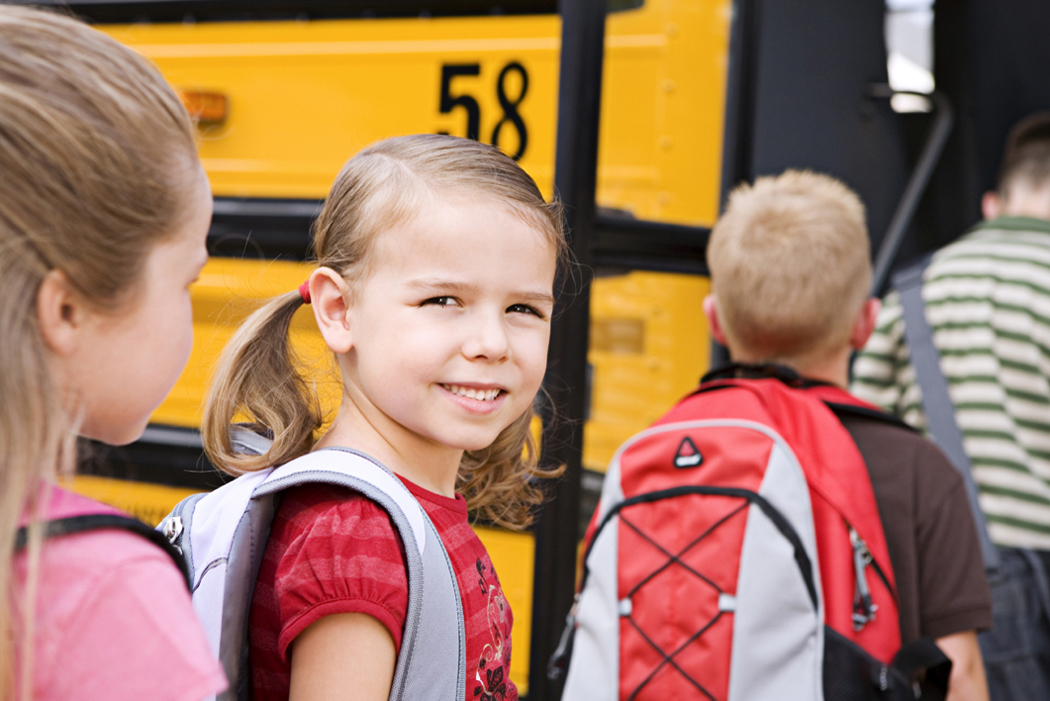 Children standing in front of school bus