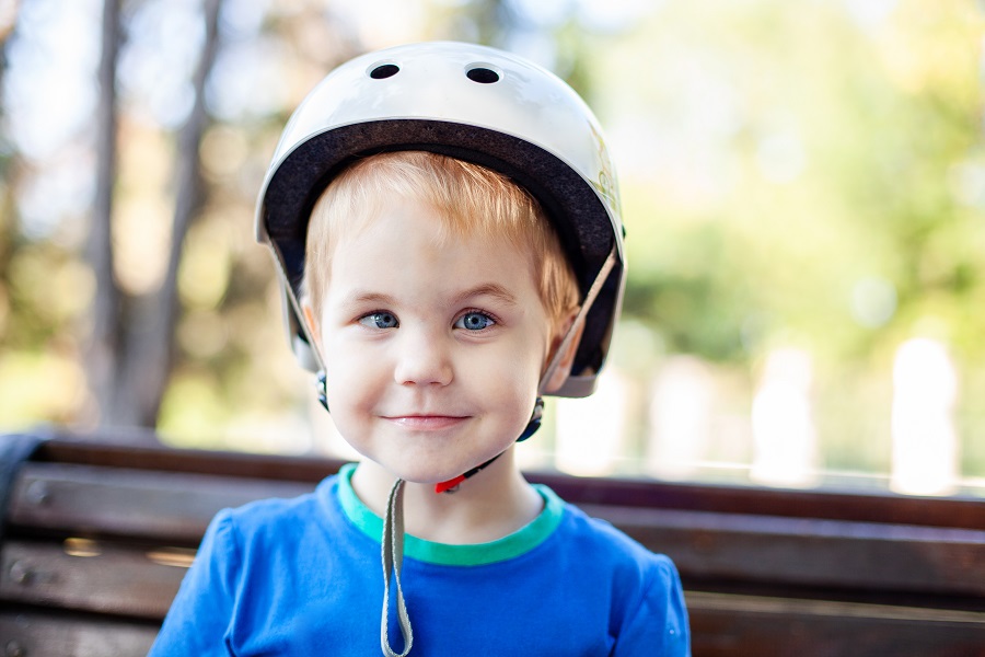young boy wearing a bike helmet experiencing an eye turn